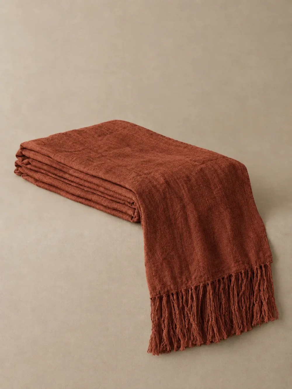 Drift Fringe Bed Runner in Rust, folded, showing the edge finish
