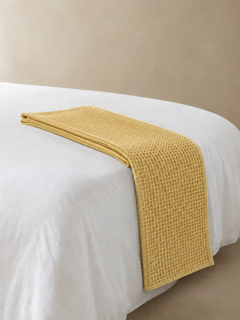 Ebb Waffle Bed Runner in Ochre, folded, showing the edge finish