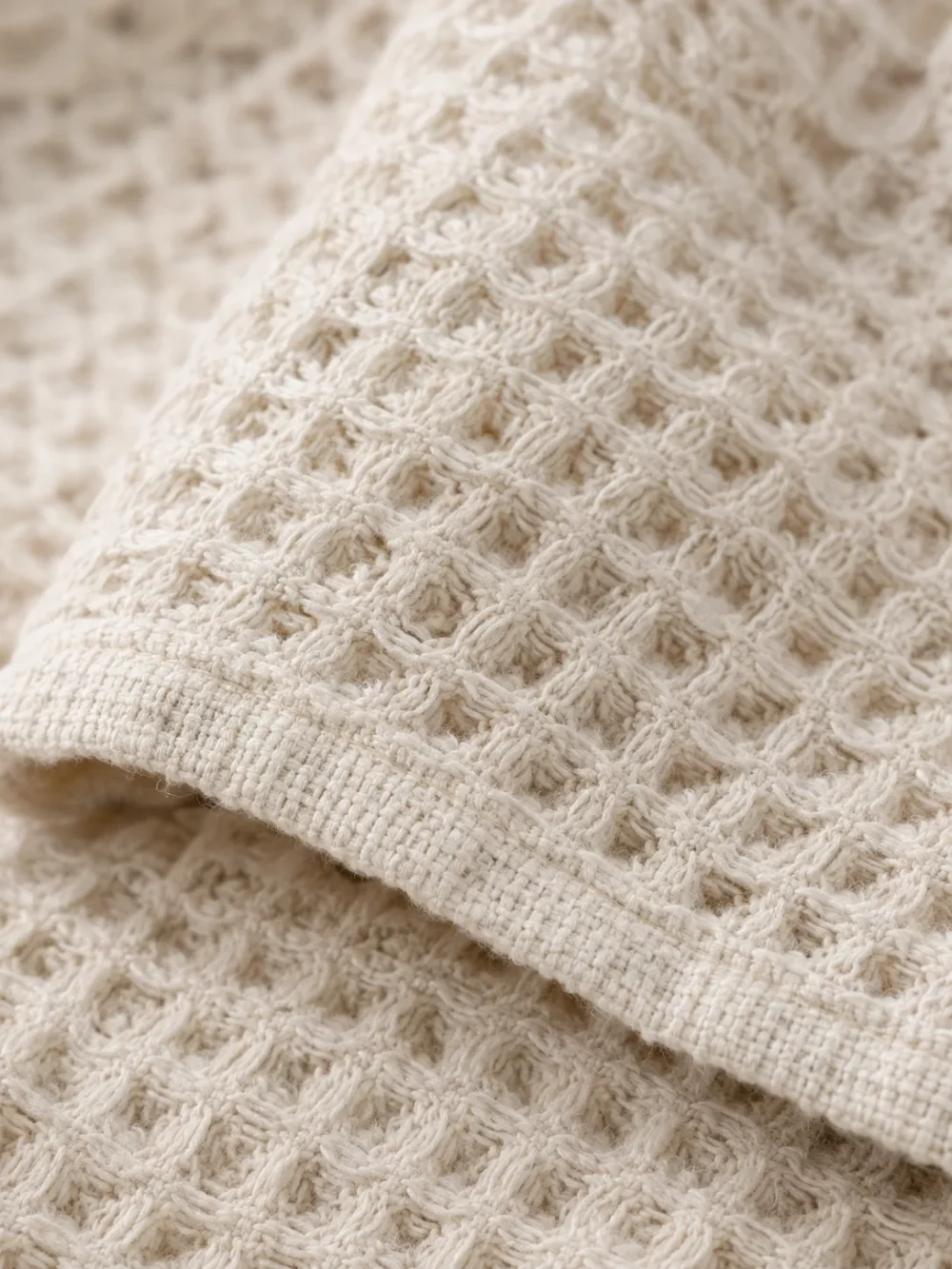 Ebb Waffle Throw in Chalk, close-up of the weave and edge