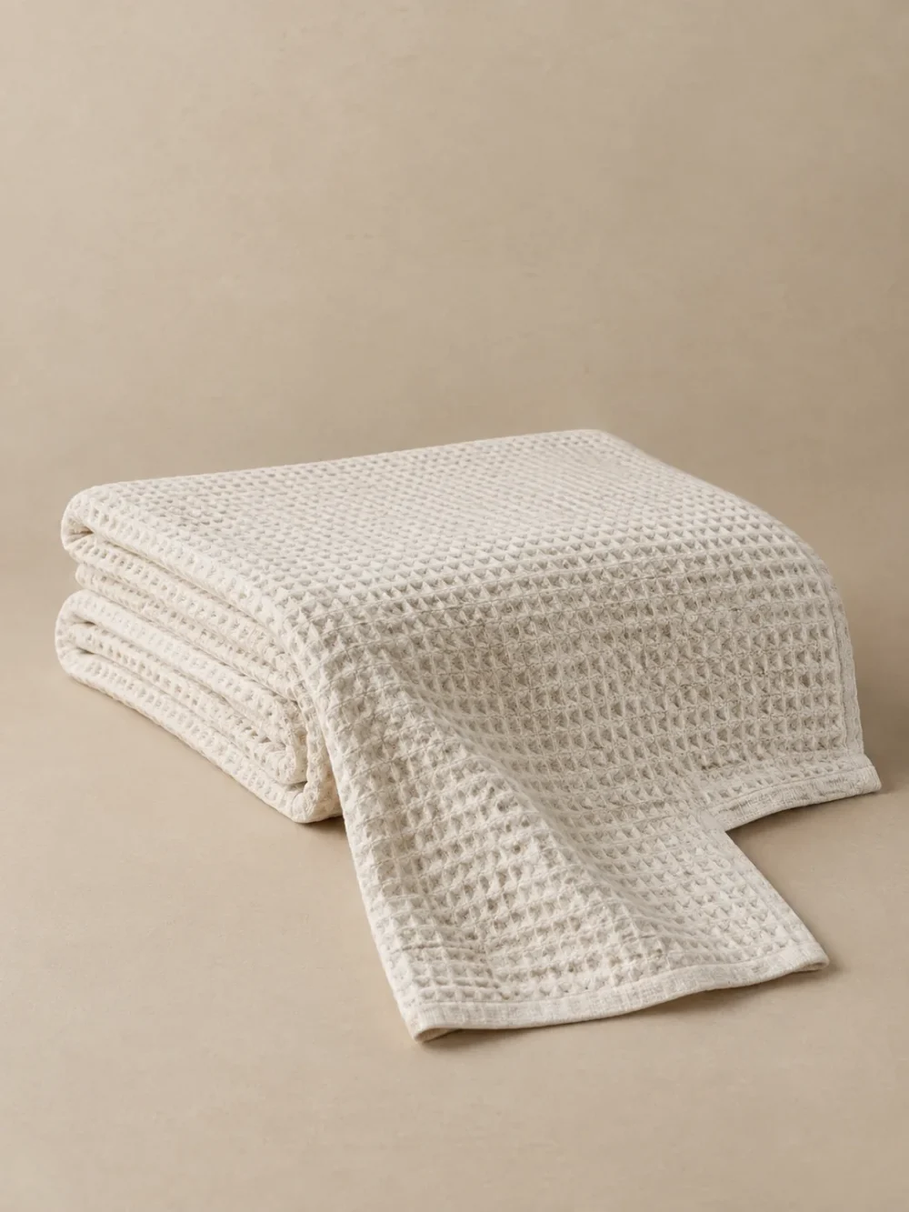Ebb Waffle Throw in Chalk, folded, showing the edge finish