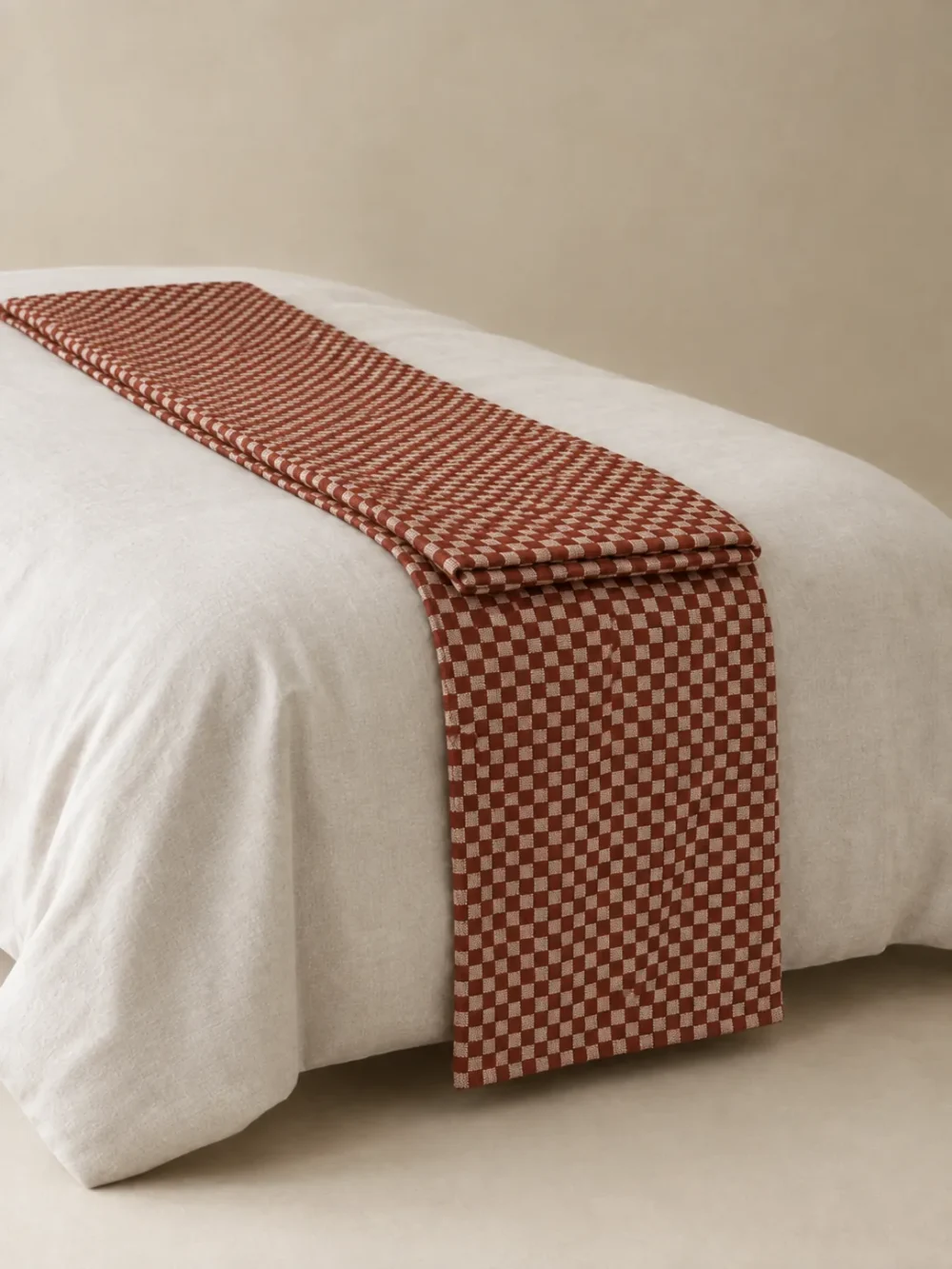 Fell Check Bed Runner in Rust, folded, showing the edge finish
