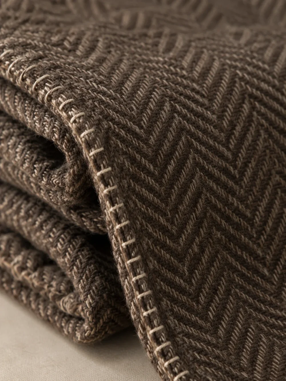 Fell Herringbone Throw in Peat, close-up of the weave and edge