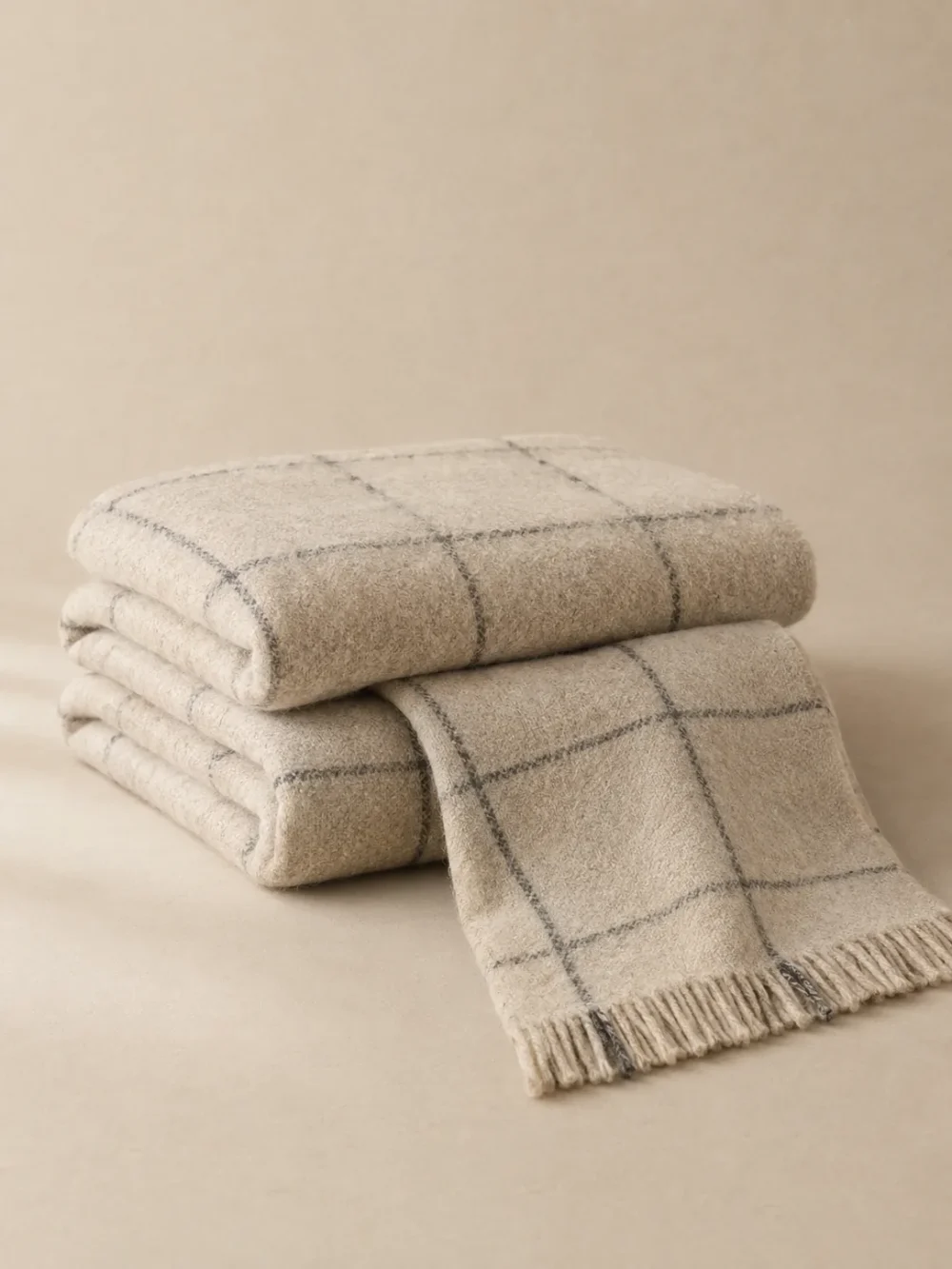 Harbour Windowpane Throw in Oat, folded, showing the edge finish