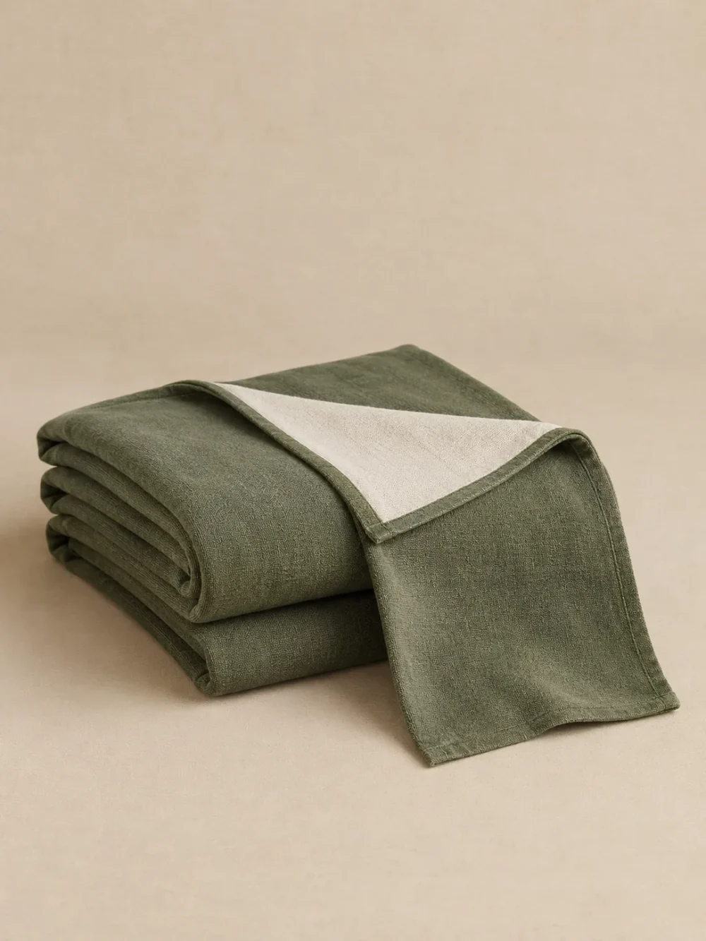 Kelp Reversible Throw in Moss, folded, showing the edge finish