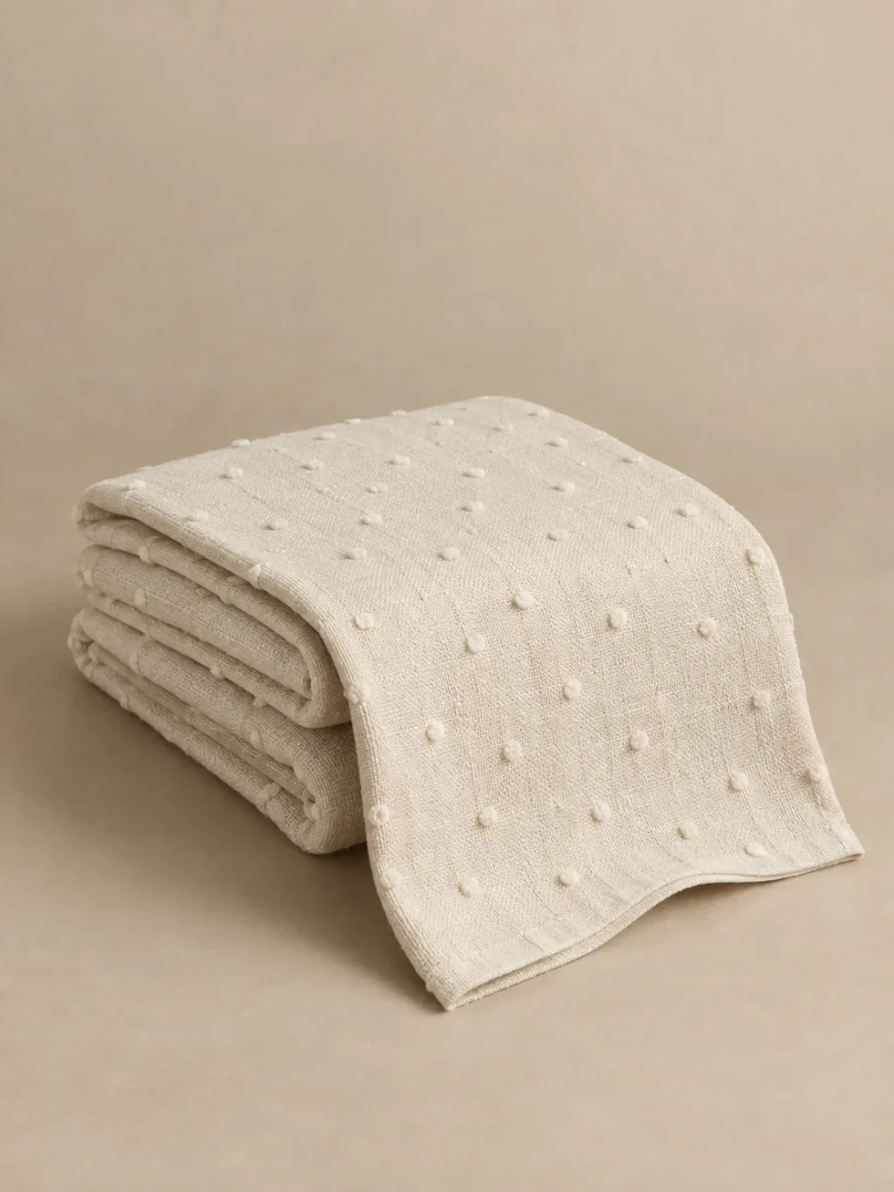 Moor Tuft Throw in Chalk, folded, showing the edge finish