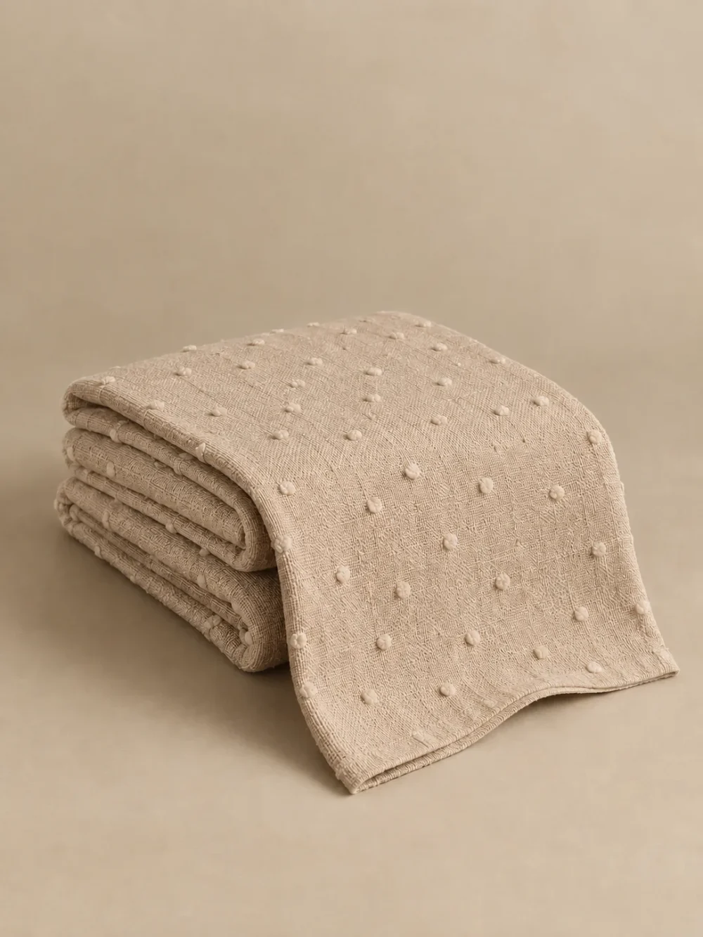 Moor Tuft Throw in Sand, folded, showing the edge finish