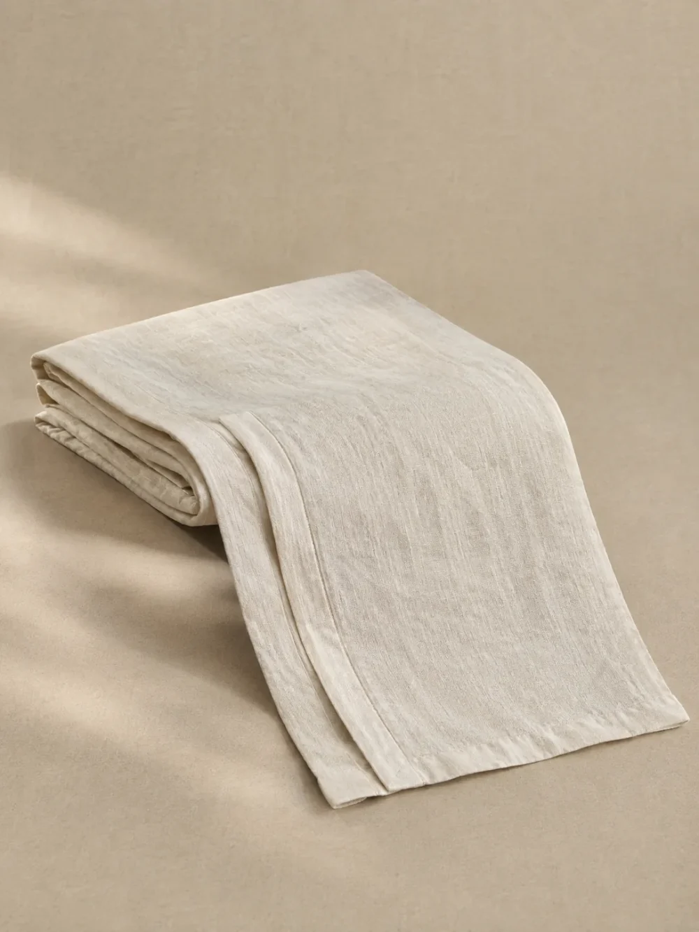 Skerry Folded Linen Runner in Chalk, folded, showing the edge finish