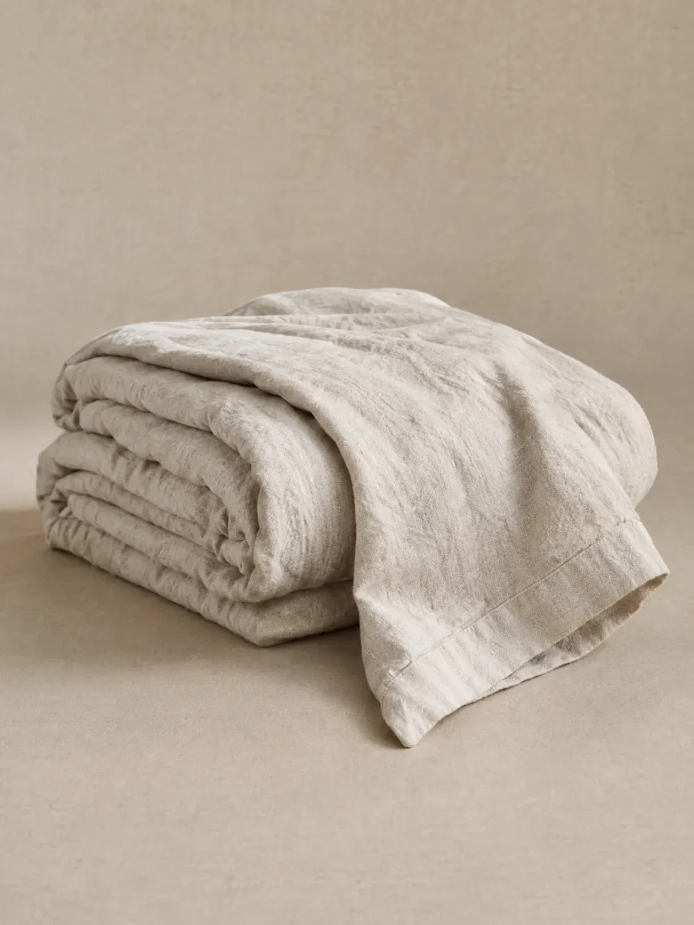 Skerry Stonewashed Linen Throw in Chalk, folded, showing the edge finish