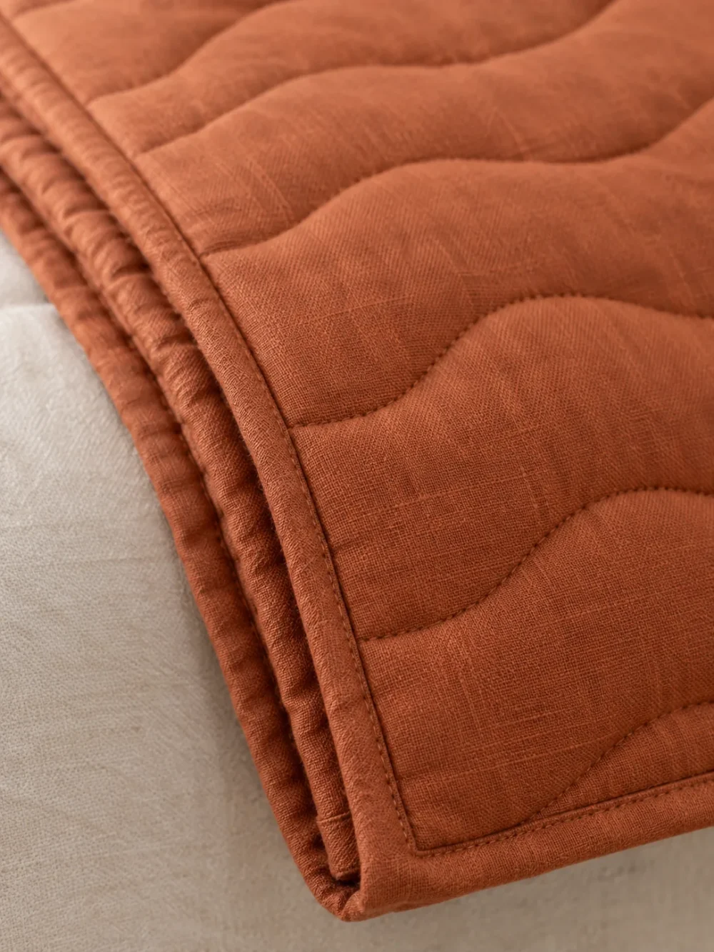 Swell Quilted Bed Runner in Clay, close-up of the end and edge