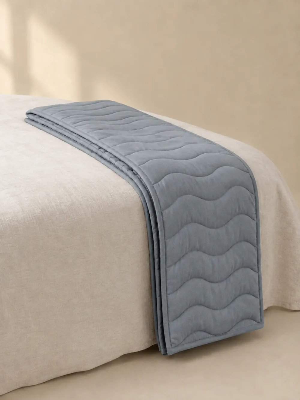Swell Quilted Bed Runner in Mist, folded, showing the edge finish