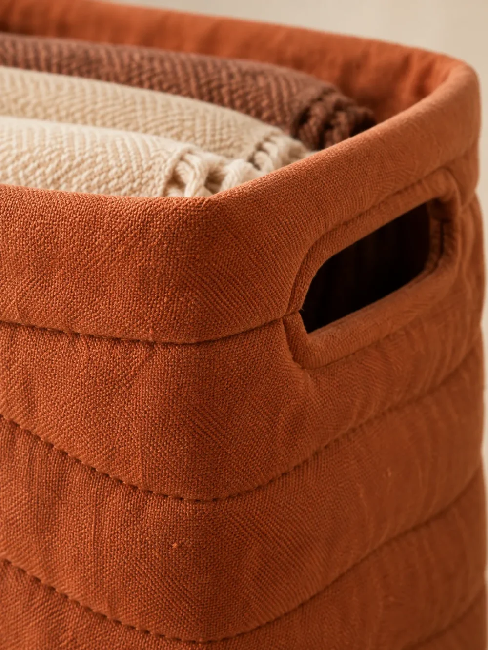 Swell Quilted Storage Bin in Clay, close-up of the seams and handle