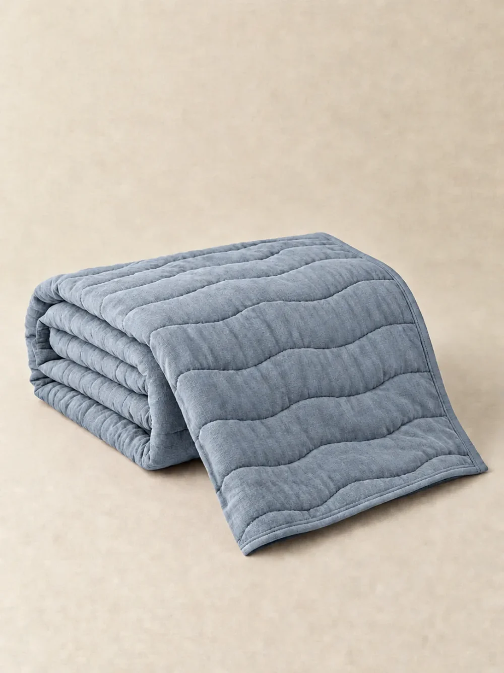Swell Quilted Throw in Mist, folded, showing the edge finish